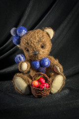 Puppet bear, decorated with blue balls with a basket of fruit.