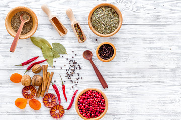 Spicy food cooking with spices and dry herbs light wooden kitchen desk background top view mockup