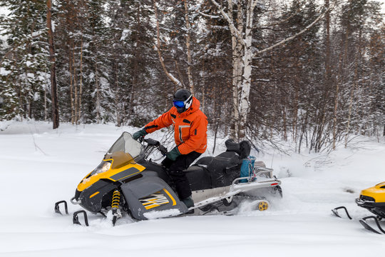 Athlete on a snowmobile.