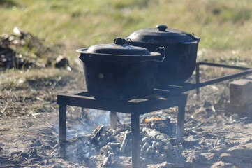Frying pans on the fire. Cooking in the nature at camping