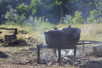 Frying pans on the fire. Cooking in the nature at camping