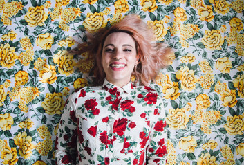 woman lying on a floral pattern