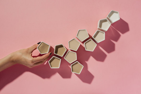 Woman making coffee ombre with geometric cups