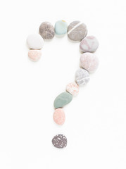 Sea pebbles, sea stones question mark. Sea pebbles background