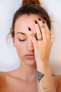 Closed portrait of woman covering half face