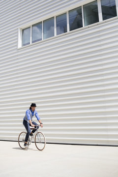 Young man cycling in urban area
