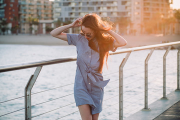 Beautiful girl on a bridge on a windy day