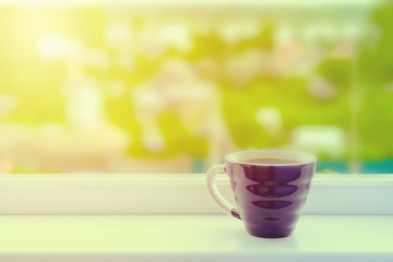 One cup of coffee for breakfast over window with beautiful view Toned photo