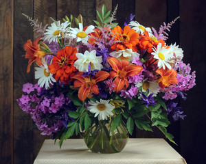 Bouquet of garden flowers in a glass jug