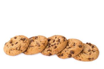 Decorative border line of round cookies with chocolate flakes isolated over the white background.