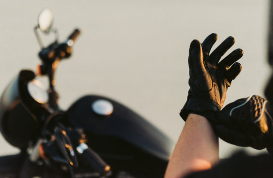 Motorcyclist putting on gloves