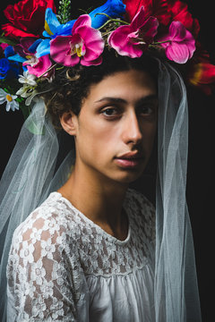 Portrait of teenager boy wearing veil and floral crown