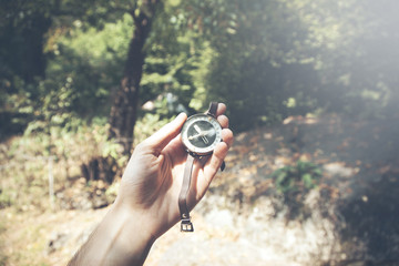 man hand compass in  forest