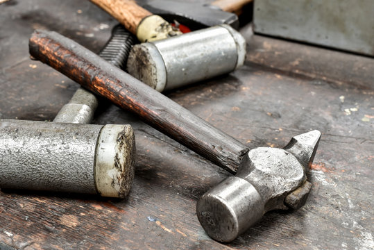 Pile of vintage hammers in shed