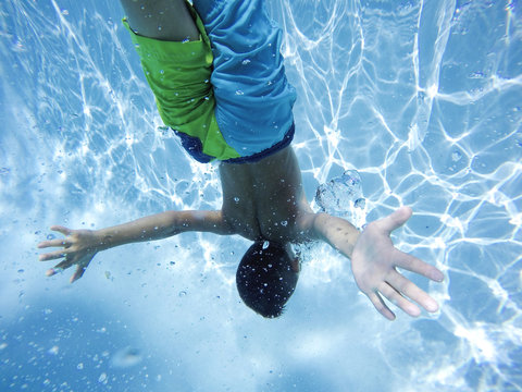 Young boy holding his breath in free dive
