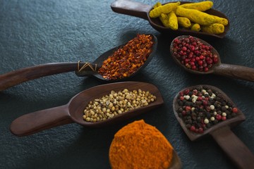 Various spices in wooden scoop