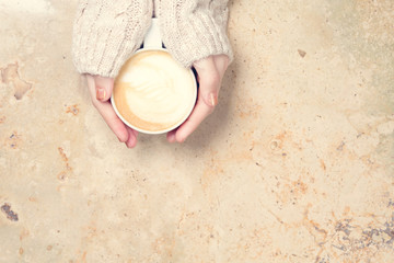Girl holding cup of coffee with latte art. Leasure time concept. Pastel colors