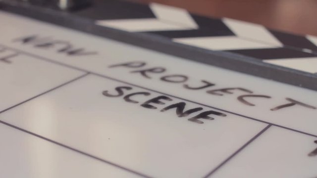 Male hand erasing scene number on movie clapperboard