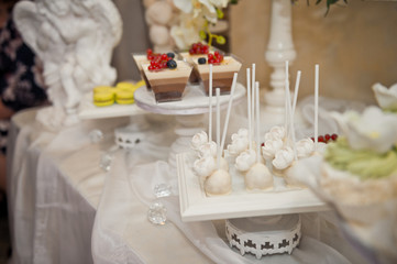 Small table with sweet delicious cakes 8043.