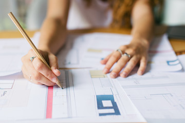 Detail of a female architect working on her studio.