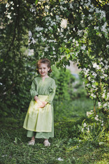 Portrait of a child standing near the branches of the cherry blossoms 8356.