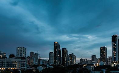 Dramatic cloud sky above city view in blue twilight