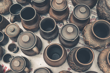 Many handmade brown clay pots, bowls, mugs