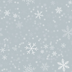 Naklejka na ściany i meble White snowflakes seamless pattern on light grey Christmas background. Chaotic scattered white snowflakes. Mesmeric Christmas creative pattern. Vector illustration.