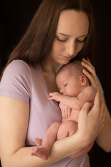 newborn baby mom hands on
