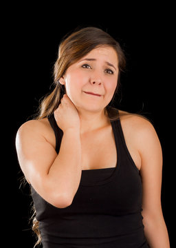 Beautiful young lady Suffer crick after workout in a black background
