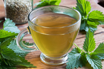 A cup of nettle tea on a wooden table