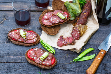 Homemade smoked sausage with rye bread and wine