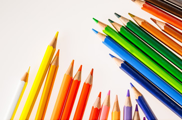 Color pencils on white background. Free space for text. Tools for drawing, education, school, creativity.