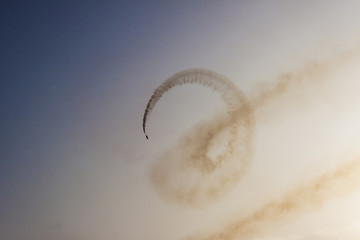 Turkish military acrobatic airplane is performing in backlight in the sunset sky. Izmir (Turkey) -...