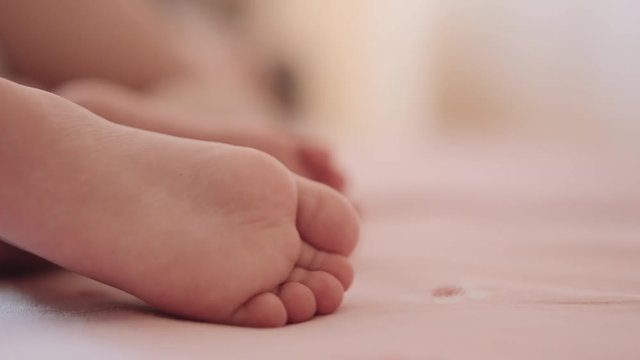 Feet of a sleeping child. Close-up.