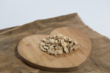 High angle view of dried gingers on wooden heart shape board