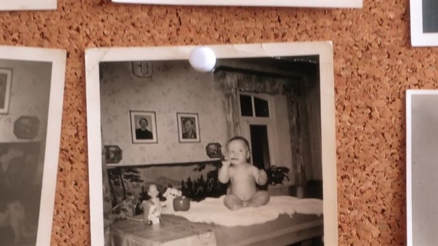 Childhood memories - Photos of a young boy on a cork pinboard