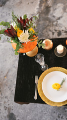 Obraz na płótnie Canvas autumn floral bouquet in a pumpkin vase for Halloween. Table setting for wedding