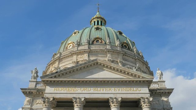 dome and inscription over main entrance of Frederick church in Copenhagen, clear blue sky