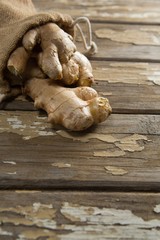 High angle view of gingers in burlap sack on weathered table