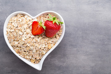 Dry rolled oatmeal in bowl.