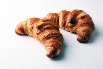 freshly baked croissants on white board, bakery concept