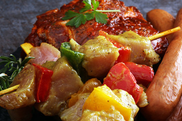 Selection of marinaded meat for bbq grilling with herbs on table
