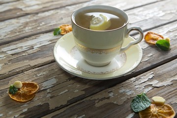 High angle view of lemon and mint leaves in ginger tea on