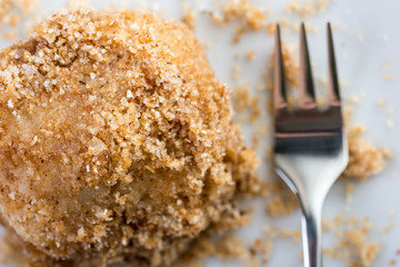 Closeup macro of plum dumplings on the plate with metal fork