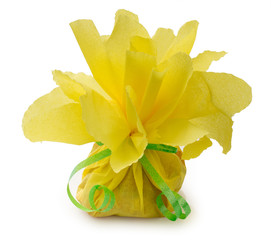 Candies wrapped in yellow crepe paper. Handmade wrapping, imitation of peony flower for children's holidays.