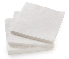 Big stack of white paper napkins isolated on a white background, close up.