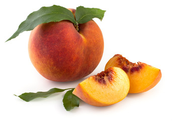 Fresh, juicy peach with slices and leaves isolated on a white background, close up.
