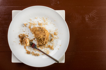 Flat lay above plum dumplings served on the plate on the brown dark wooden table