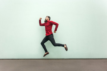 Fototapeta na wymiar Profile happiness jumping man in red shirt with beard and mustache, casual style.